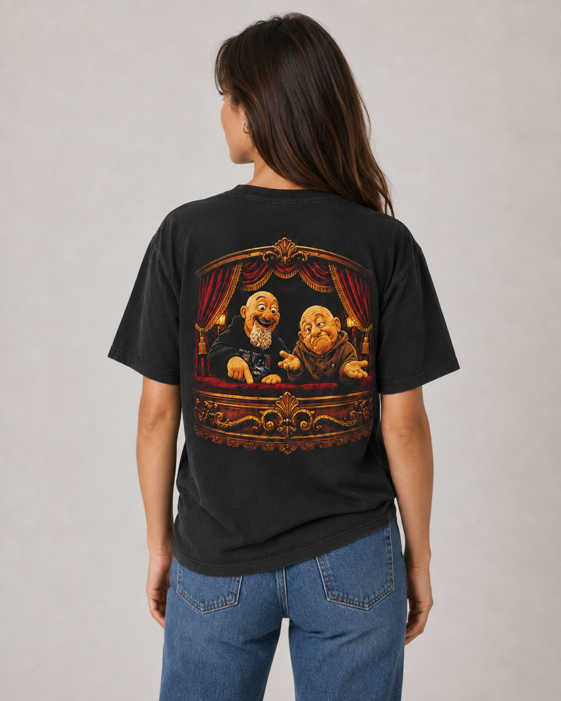 Female model wearing a black MFJ Theatre Critics heavyweight garment-dyed tee, showing the large illustrated back graphic