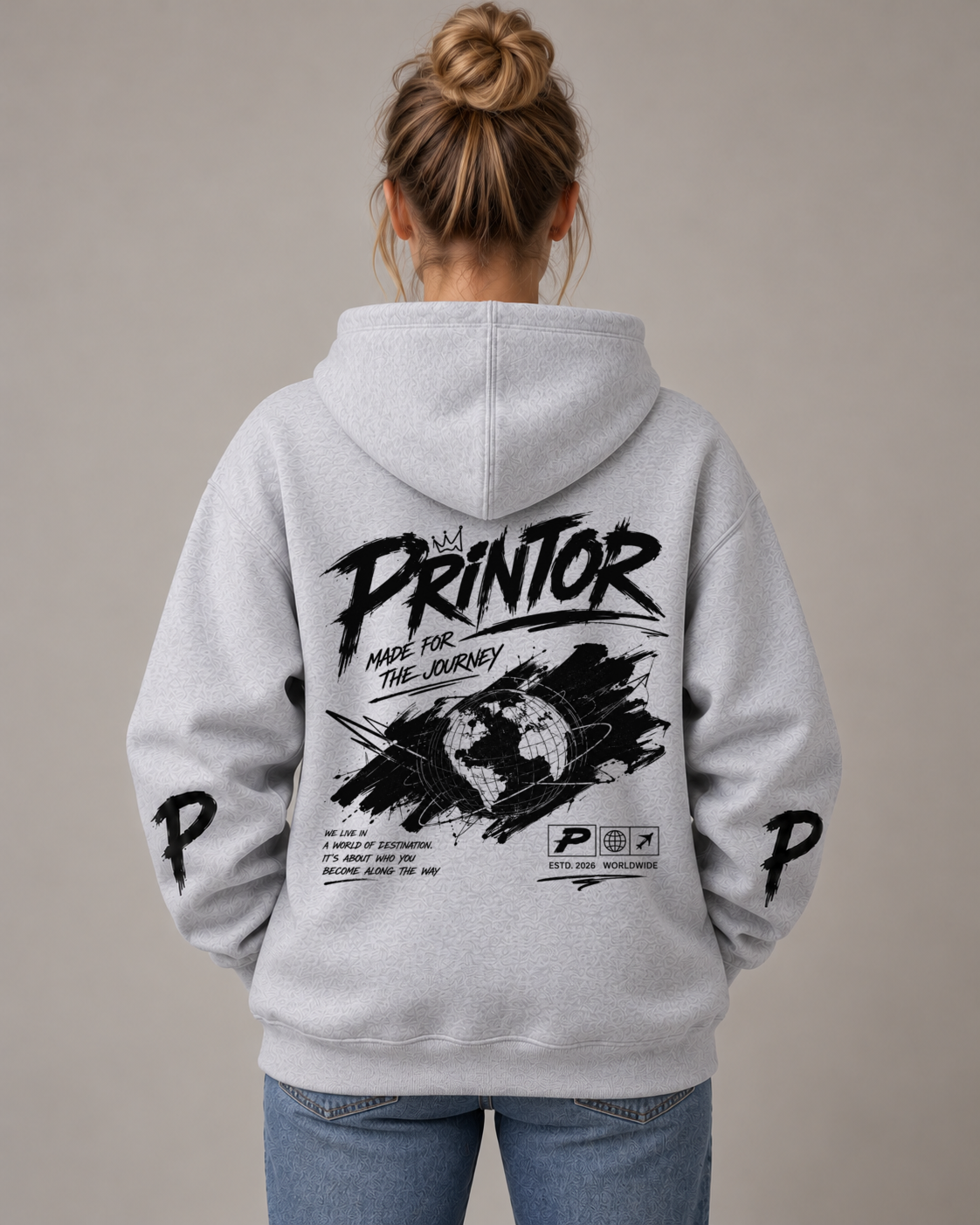 Female model wearing the PRINTOR SJ-001 Globe heavyweight hoodie in Grey Marle, back view showing the centred Globe artwork and sleeve prints.