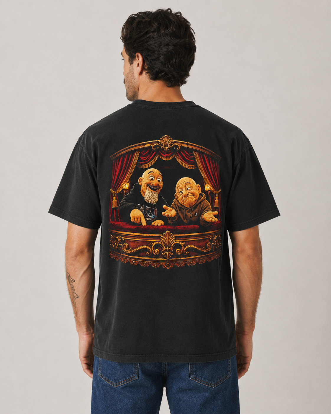 Male model wearing a black MFJ Theatre Critics heavyweight garment-dyed tee, showing the large illustrated back graphic